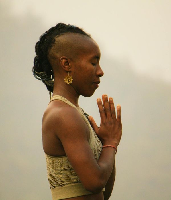 Woman in a calm yoga pose, embodying balance and serenity.